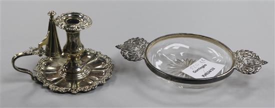 A George V silver mounted 2 handled glass dish and a plated chamberstick.